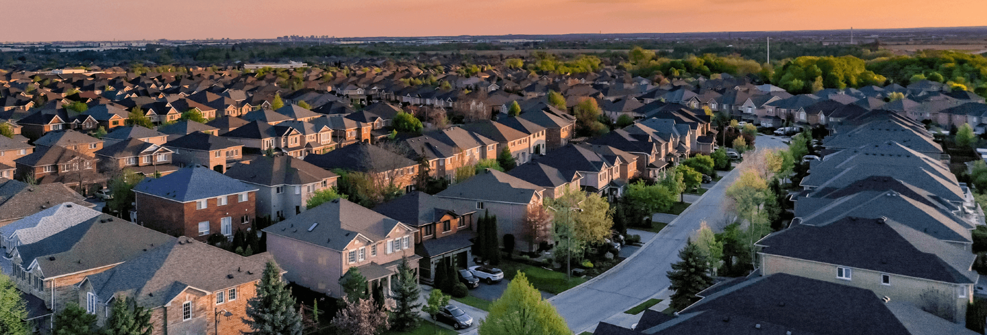 Neighborhood of houses in the suburbs during sunset.