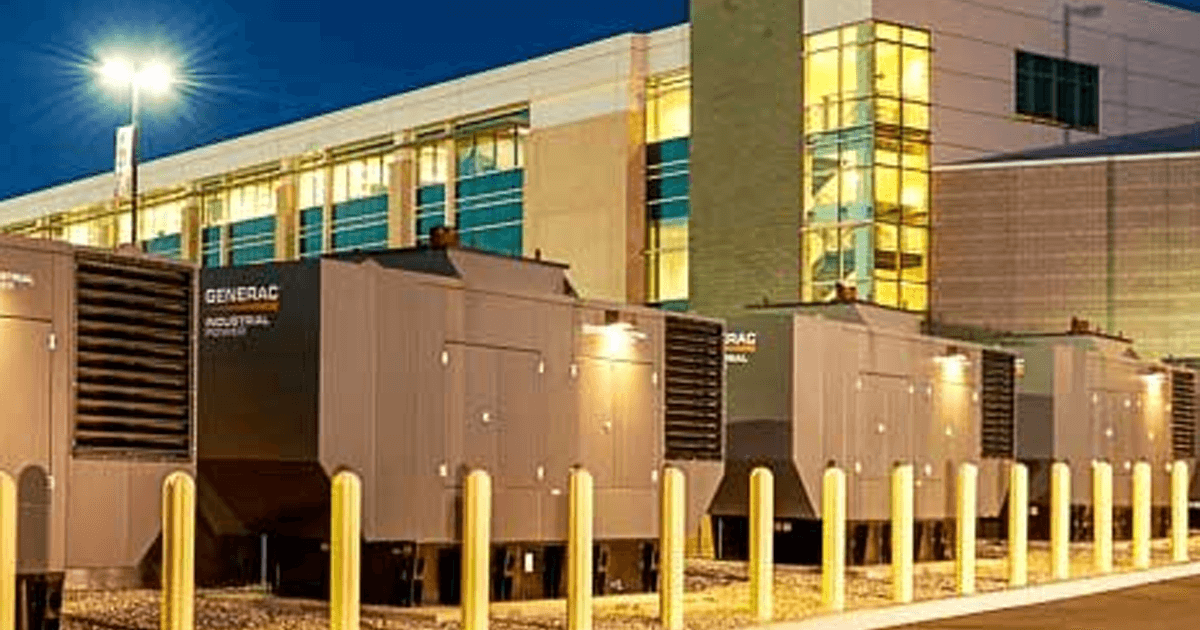 Group of Generac Industrial Power generators outside of a large building.