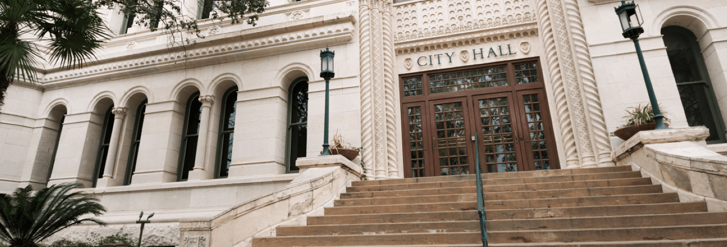 Front view of City hall entrance steps during the day.