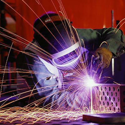 Manufacturing worker creating parts for a generator.