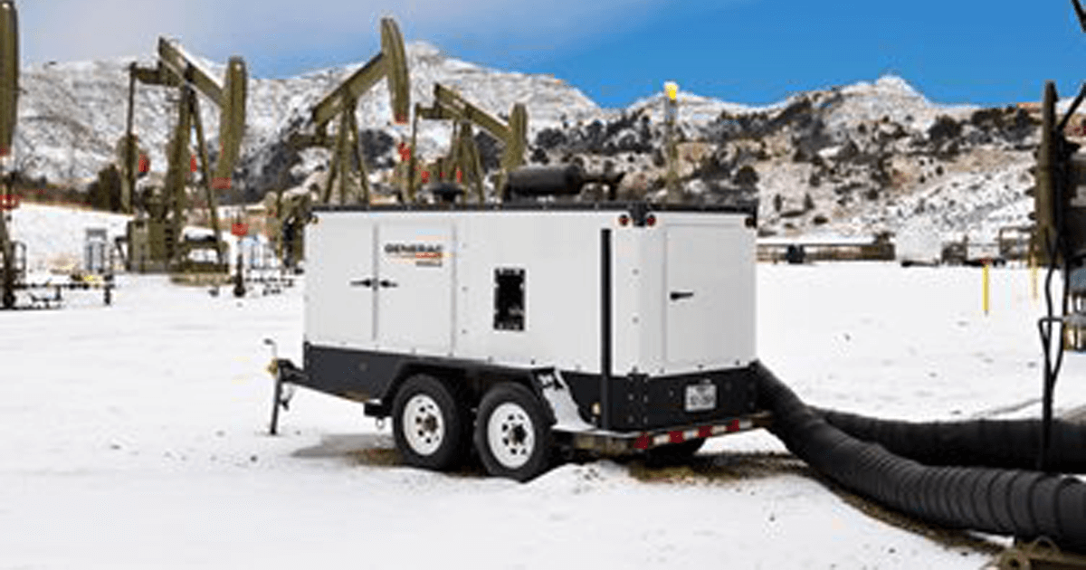 Generac mobile generator in an oil field of snow.