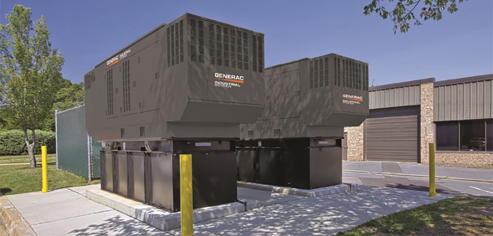 Two Generac Industrial Power bi-fuel generators on a designated platform outside.