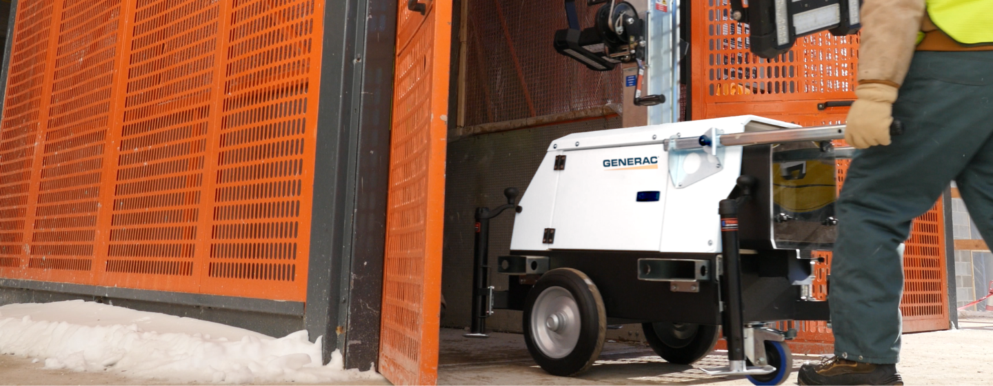  Image of a portable Generac industrial generator being taken out of storage