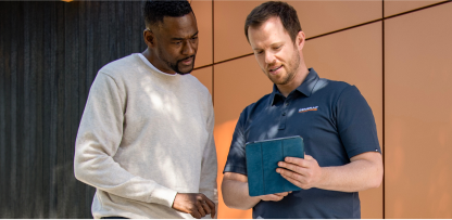  Image of two people looking at a tablet