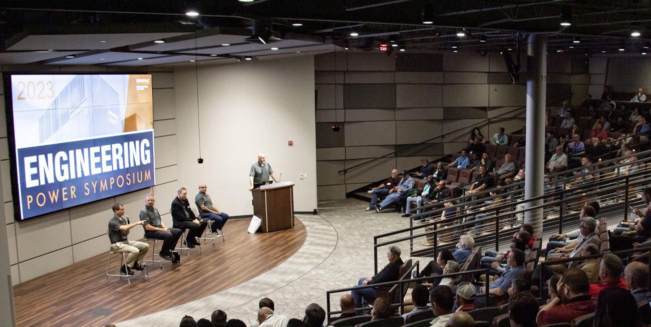 5 presenters on stage in a full auditorium at the Engineering Power Symposium full image