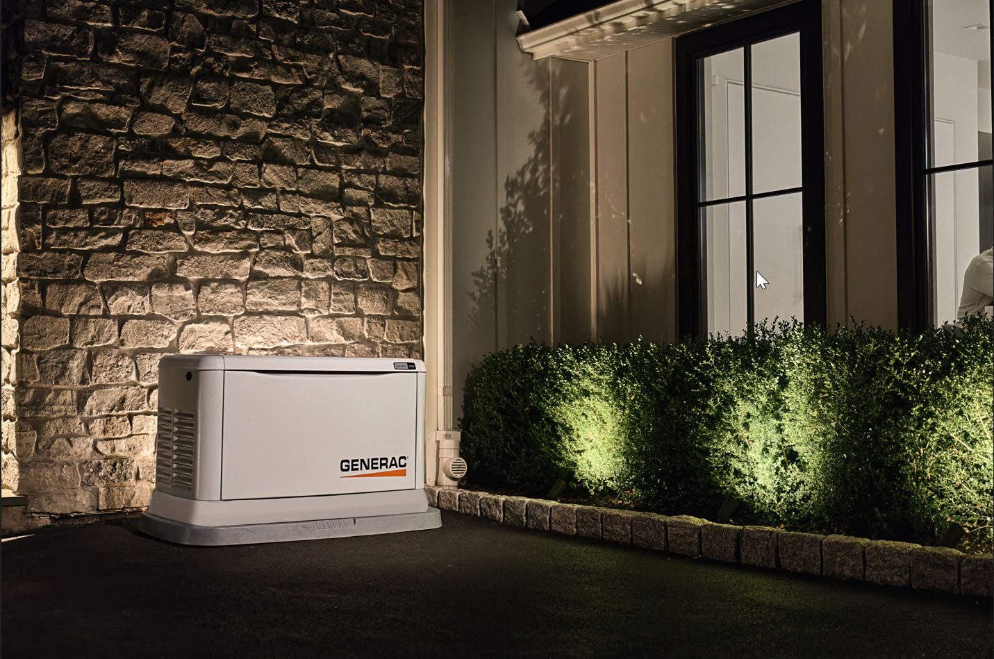 Home standby generator outside of the home at night.