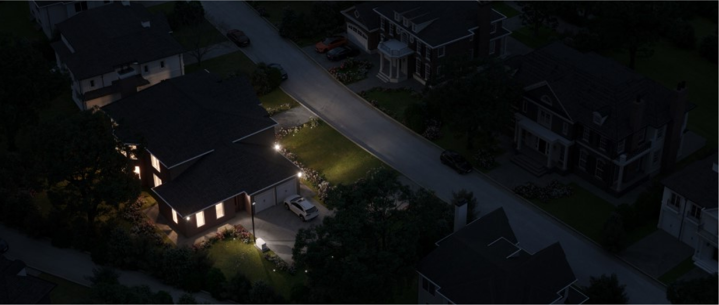 home on street darkened by power outage lit up by a backup generator
