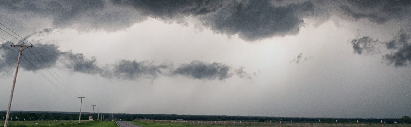 dark clouds rolling over a field