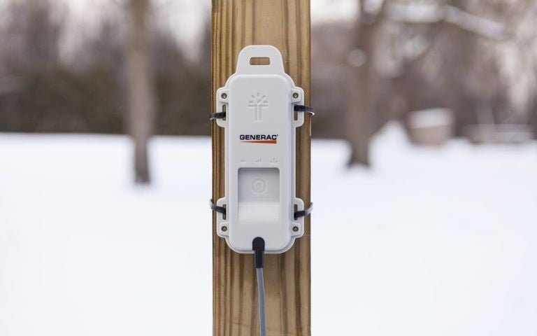 A Generac LTE fuel level monitor on a post outside.